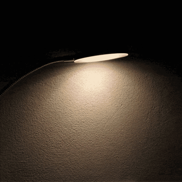 a light is shining on a wall with a black background