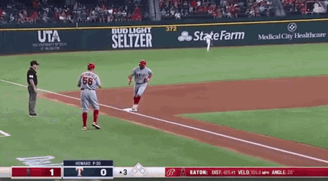 a baseball game is being played in front of a bud light seltzer advertisement
