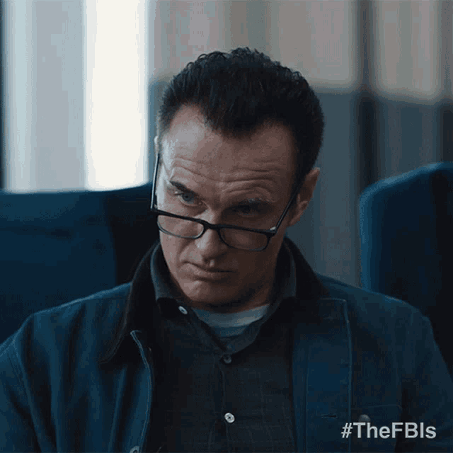 a man wearing glasses has the hashtag #thefbls on the bottom