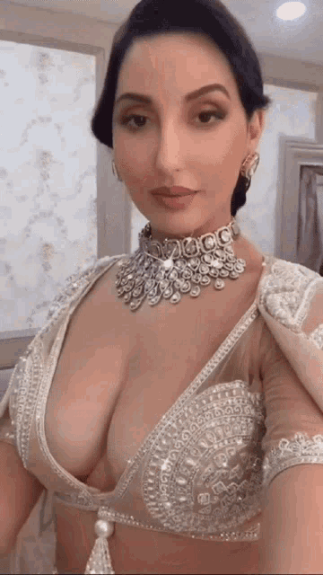 a woman with a very large breast is wearing a necklace