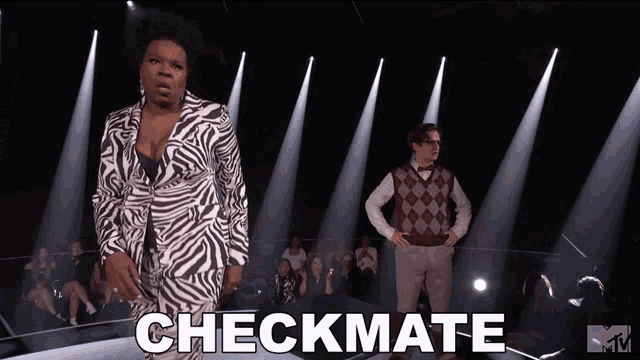 a woman in a zebra print suit stands on a stage with the words checkmate above her