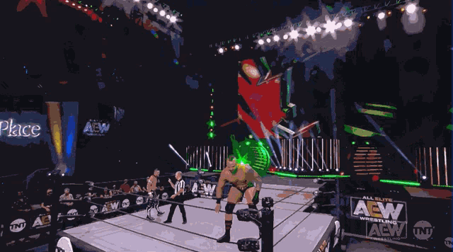 a wrestler in a ring with a sign that says all elite wrestling