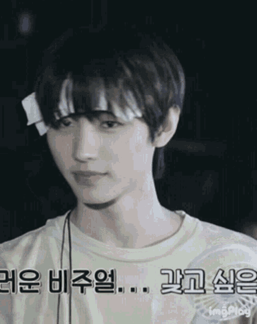 a young man with a bandage on his head holds a fan