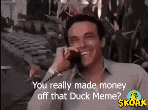 a man is smiling while talking on a cell phone and says `` you really made money off that duck meme ? ''