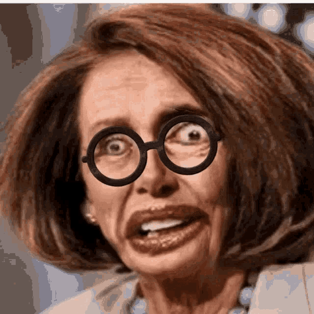 a close up of a woman wearing glasses and making a face