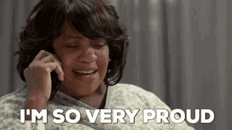 a woman in a hospital gown is talking on a cell phone and crying .