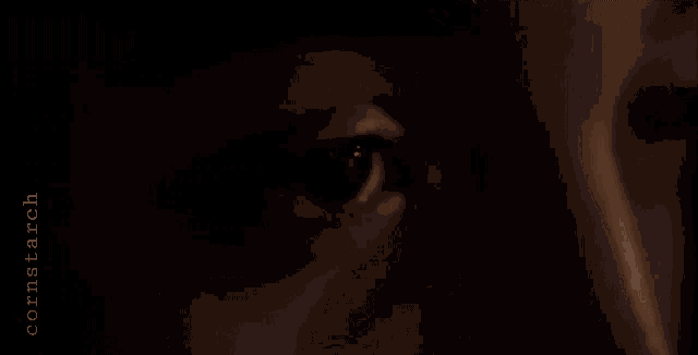 a close up of a person 's eye in the dark