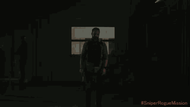 a man in a plaid shirt is standing in a dark room with #sniperroguemission written in red