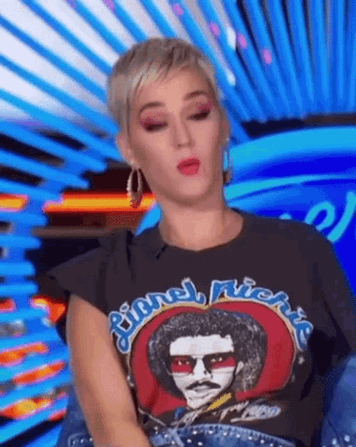 a woman wearing a black t-shirt with a picture of a man with a mustache on it .