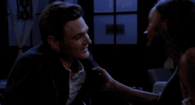 a man and a woman are looking at each other