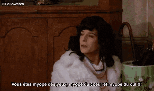 a woman in a fur coat is talking to someone in french .