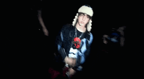 a blurry picture of a person wearing a hat and a jacket that says ' a ' on it