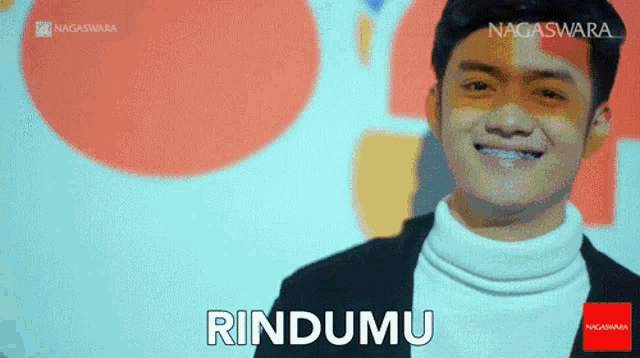 a man is smiling with the word rindumu on the bottom