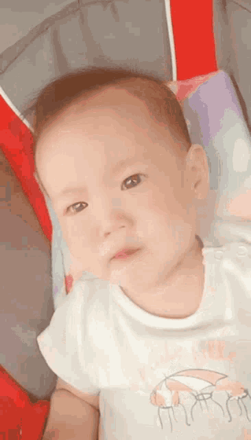 a baby is wearing a white shirt that says ' i love you ' on it