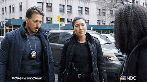 a man and a woman are standing next to each other with the nbc logo on the bottom right