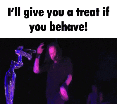 a man is singing into a microphone with the words i 'll give you a treat if you behave