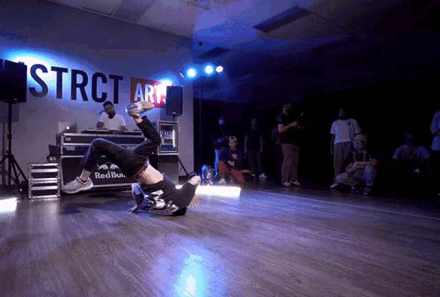 a man is doing a trick in front of a sign that says strct art