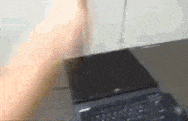 a blurry picture of a person 's hand reaching for a black box