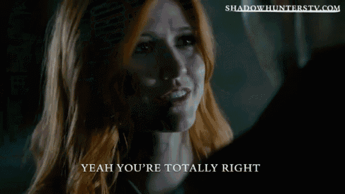 a man and a woman standing next to each other with shadowhunterstv.com written on the bottom