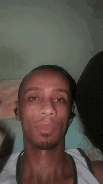 a man with a beard is making a funny face with his hands