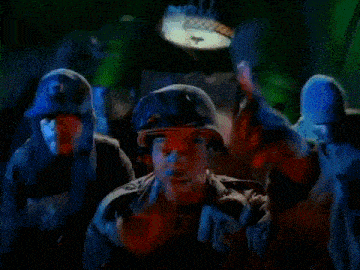 a man is wearing a helmet and goggles in a room with green lights