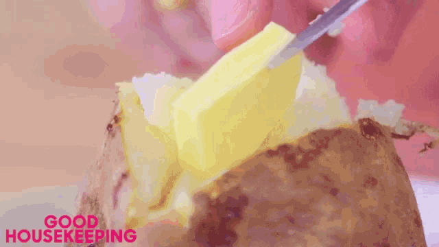 a baked potato with a slice of butter on it and the words good housekeeping above it