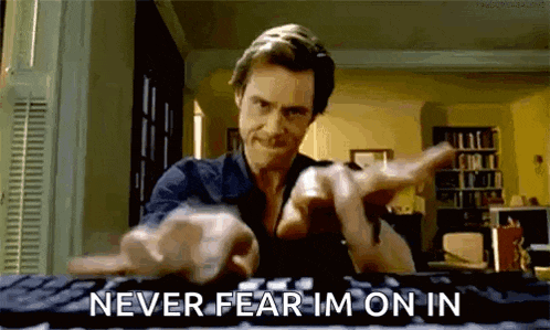 a man is typing on a keyboard with the words `` never fear im on in '' written below him .