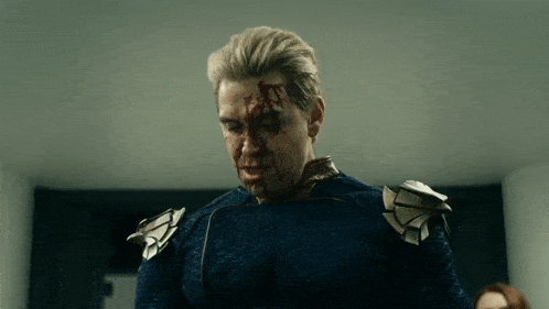a man with blood on his face is wearing a blue suit