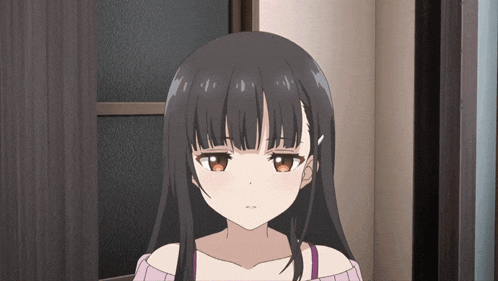 a girl with long black hair and brown eyes is looking at the camera