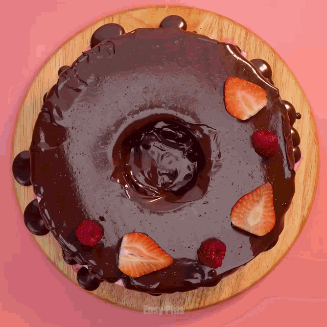 a chocolate cake with strawberries and raspberries on it