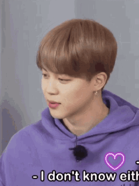 a young man wearing a purple hoodie is smiling and says why don t you know