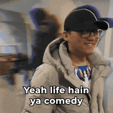 a man wearing glasses and a hat is smiling and says yeah life hain ya comedy
