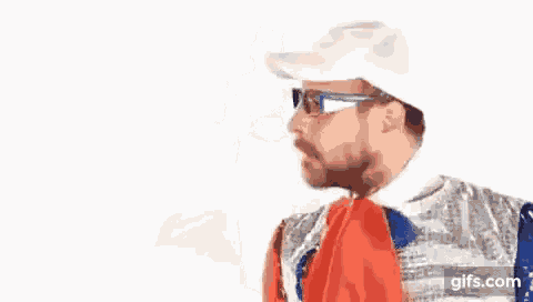 a man with glasses and a scarf around his neck is wearing a french flag .