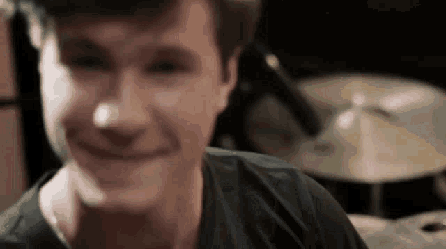 a close up of a man 's face with a microphone in the background .