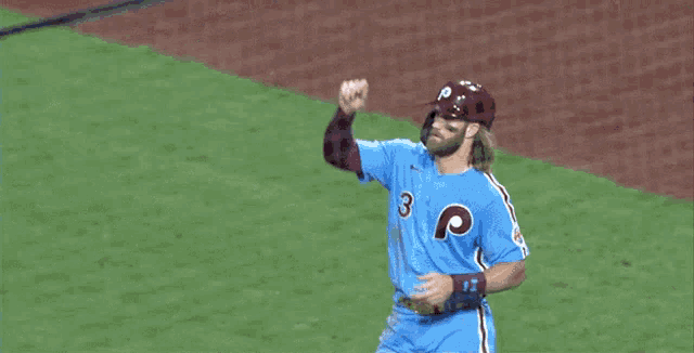 a baseball player wearing a blue jersey with the letter p on the front