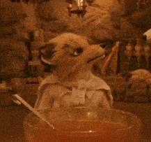 a stuffed animal is holding a bowl of soup with a spoon in it