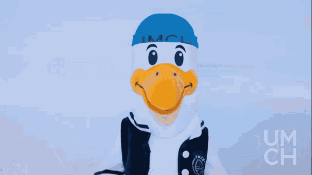 a mascot wearing a blue hat and a black and white jacket with um ch written on the sleeves