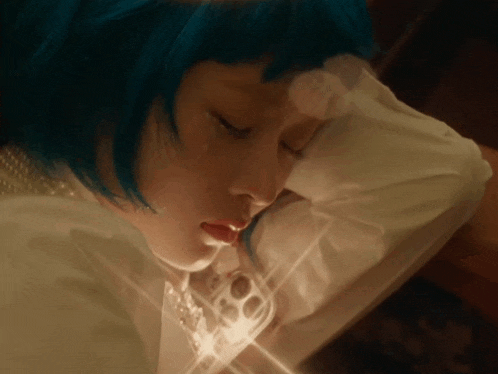 a girl with blue hair and white pearls is sleeping with her eyes closed