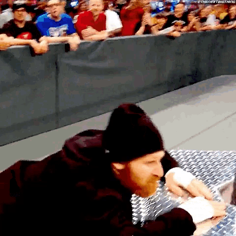 a man in a black beanie is laying on a metal surface in front of a crowd with the hashtag thenextbigthing