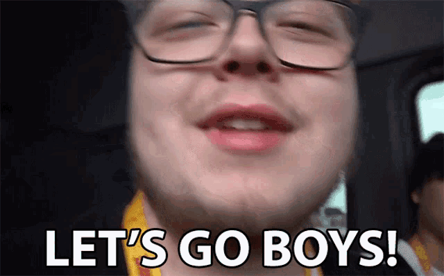 a man with glasses and a beard says let 's go boys