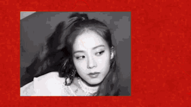 a girl is standing in front of a red curtain with the words tizzy allz ever written on it .
