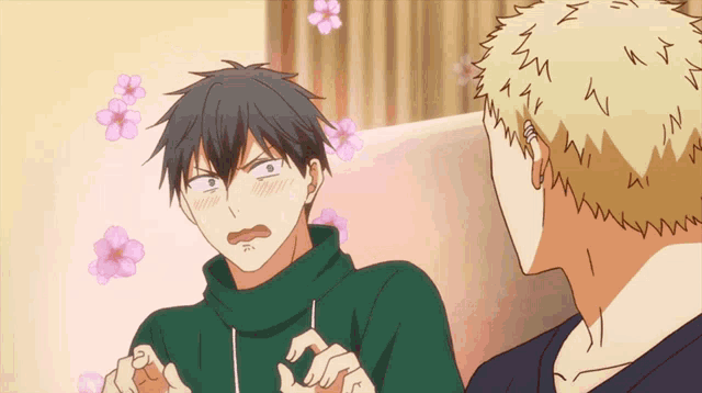 a man in a green sweater is sitting next to another man in a yellow shirt