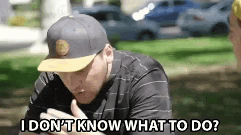 a man wearing a hat is talking on a cell phone and says `` i don 't know what to do '' .