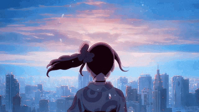 a girl with a flower in her hair is looking out over a city
