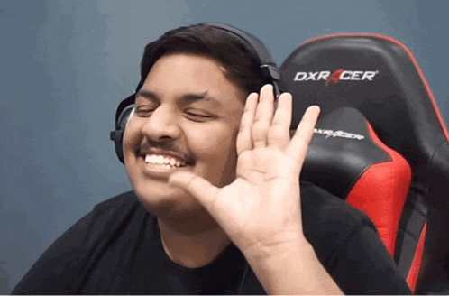 a man wearing headphones sits in a dxr cer chair