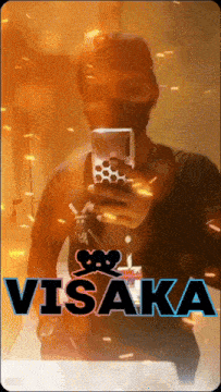 a man taking a picture of himself with the name visaka on the bottom right