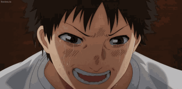 a close up of a person 's face with tears coming out of his eyes