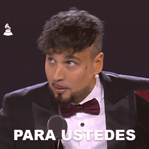 a man in a tuxedo with a bow tie says para ustedes