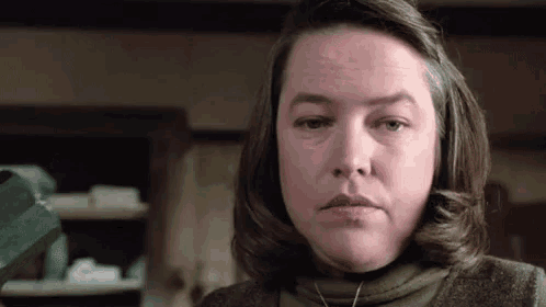a close up of a woman 's face in a kitchen .