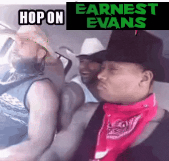a man wearing a cowboy hat and a pink bandana is sleeping in a car